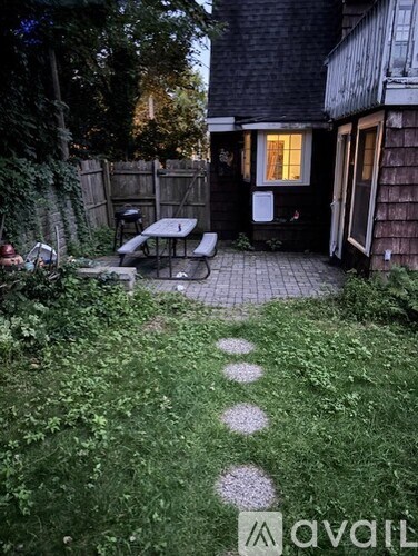 A backyard with a patio and a table.