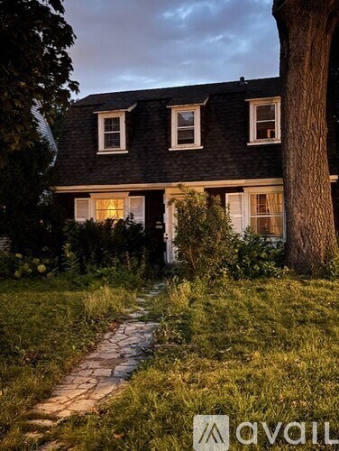 A house with a pathway leading to the front door.