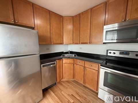 A kitchen with wooden cabinets and stainless steel appliances.