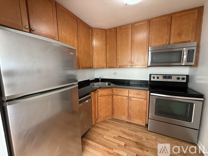 A kitchen with wooden cabinets and stainless steel appliances.
