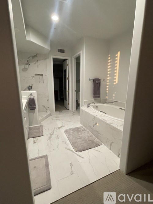 A bathroom with a marble floor and walls.