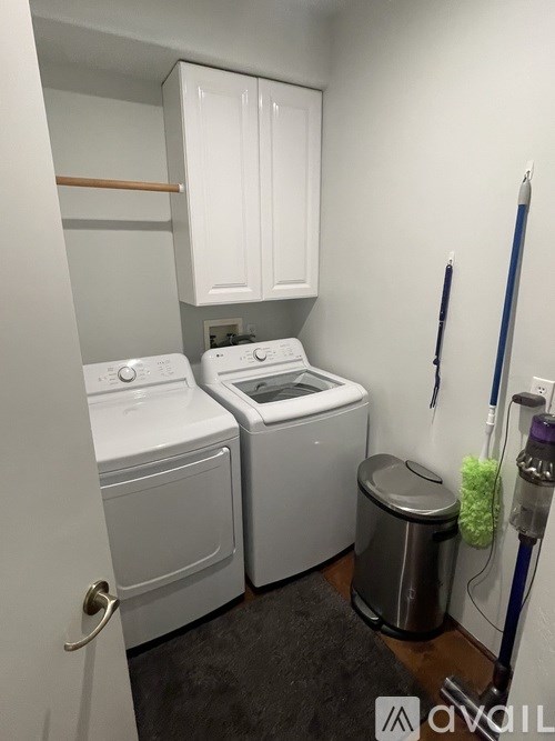 A small laundry room with a washer and dryer.