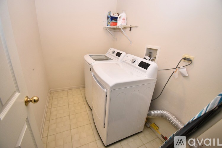 A small laundry room with a washer and dryer.