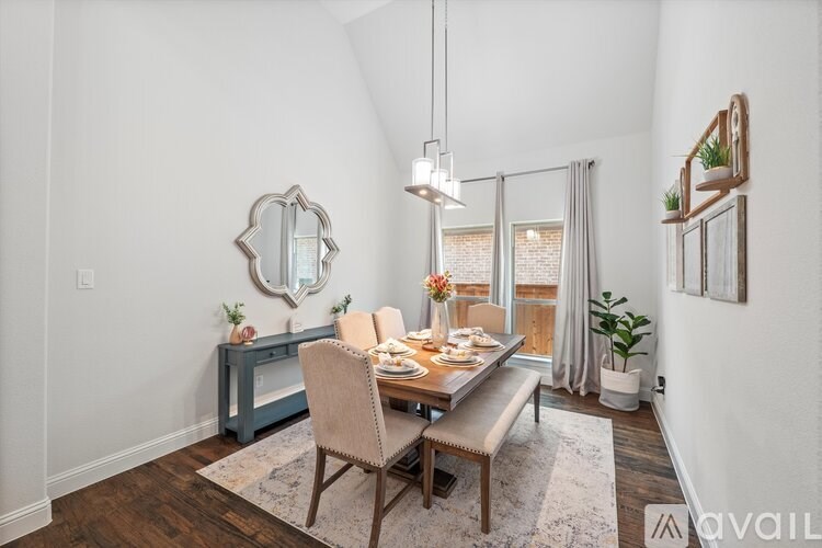 A dining room with a wooden table and chairs.