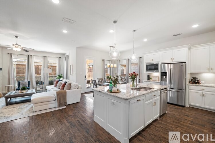 A modern kitchen with white cabinets and a center island.