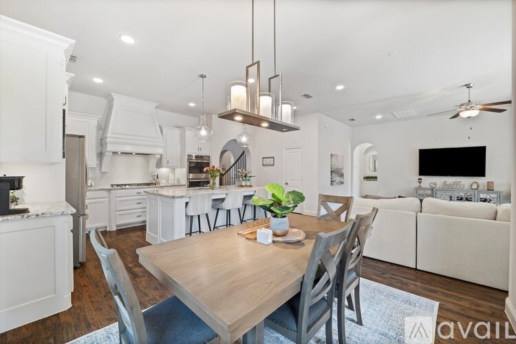 A modern kitchen with a dining table and chairs.