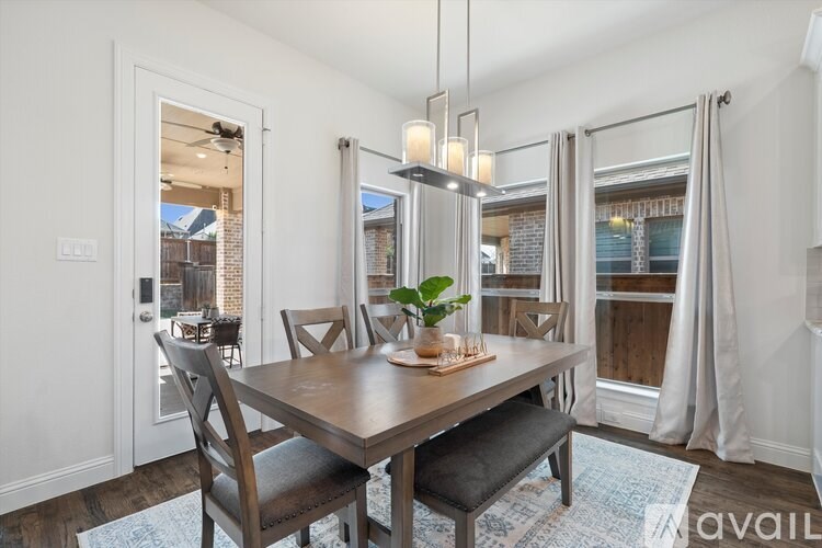 A dining room with a wooden table and chairs.