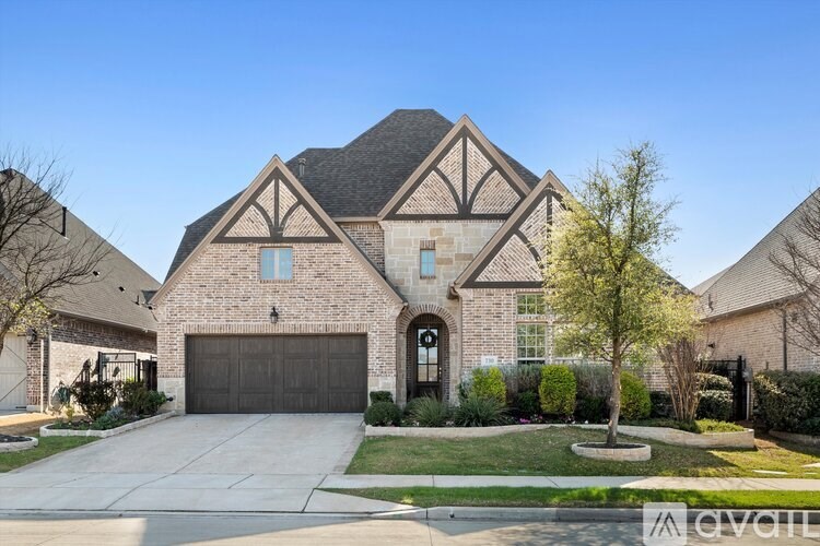 A large house with a driveway in front.