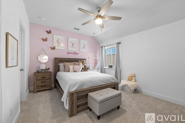 A bedroom with a bed, a bench, and a teddy bear.
