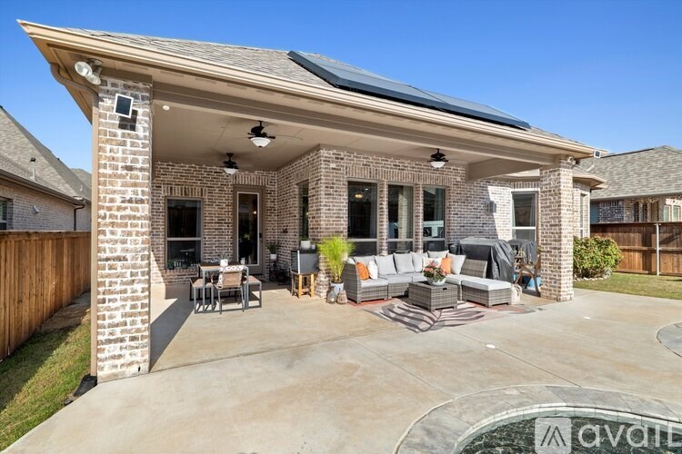 A patio area with a table and chairs is available for rent.