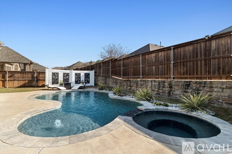A large outdoor swimming pool with a waterfall feature.