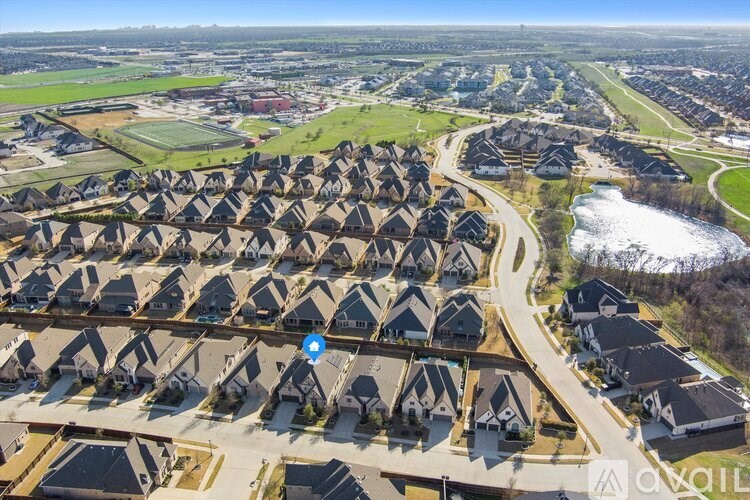 A bird's eye view of a residential area with houses and a river.