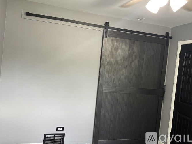 A black sliding door in a room.