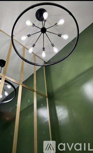 A chandelier with eight lights hangs from a ceiling.