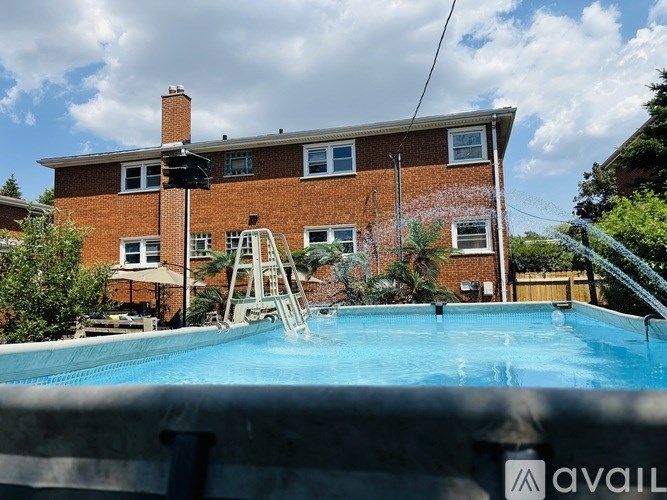 A house with a pool in front.