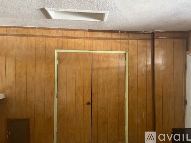 A wooden door with a glass window in the middle.