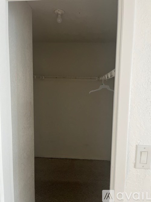 A white doorway with a coat hanger on the wall.