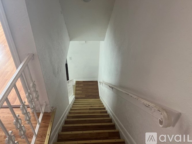 A staircase with wooden steps and a metal railing.