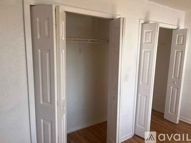 Three white doors are open in a room.
