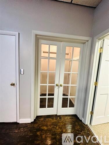 A white door with a glass panel and a handle.