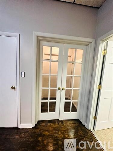 A white door with a glass panel and a handle.