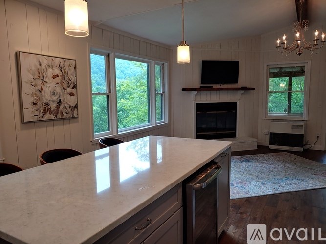 A kitchen with a marble countertop and a chandelier.