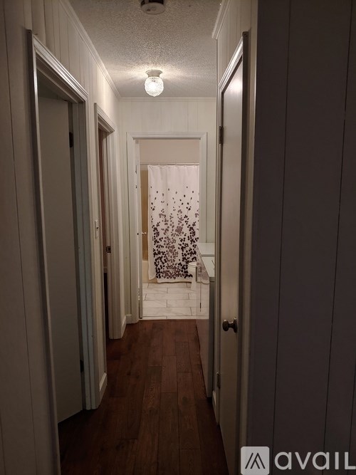A hallway with a door on the right and a door on the left.