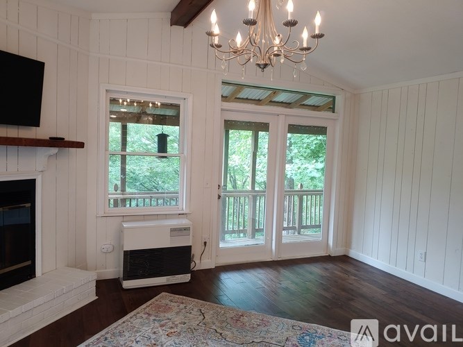A room with a fireplace and a chandelier.