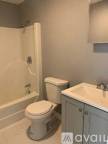 A white toilet sits next to a sink in a bathroom.