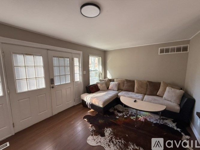 A living room with a couch, a rug, and a table.