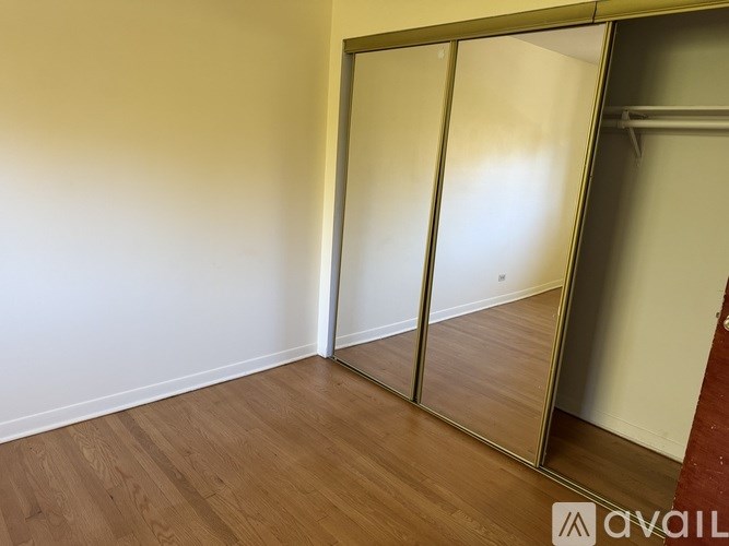 A room with a sliding door and wooden floor.