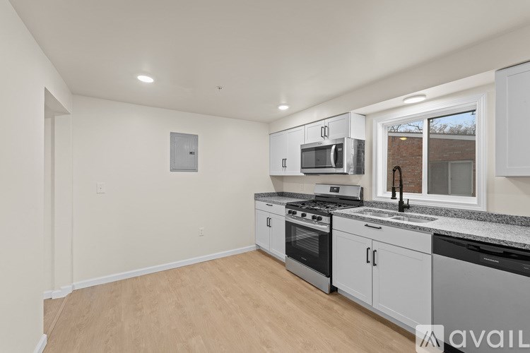 A kitchen with white cabinets and stainless steel appliances.