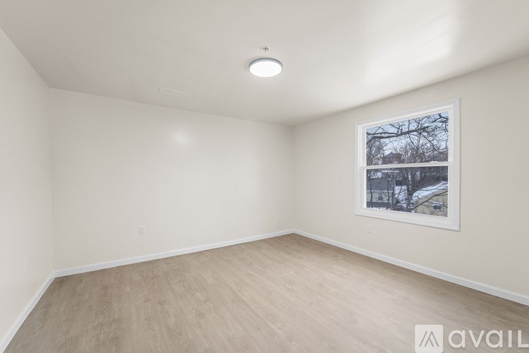 A room with a picture of a tree in winter hanging on the wall.