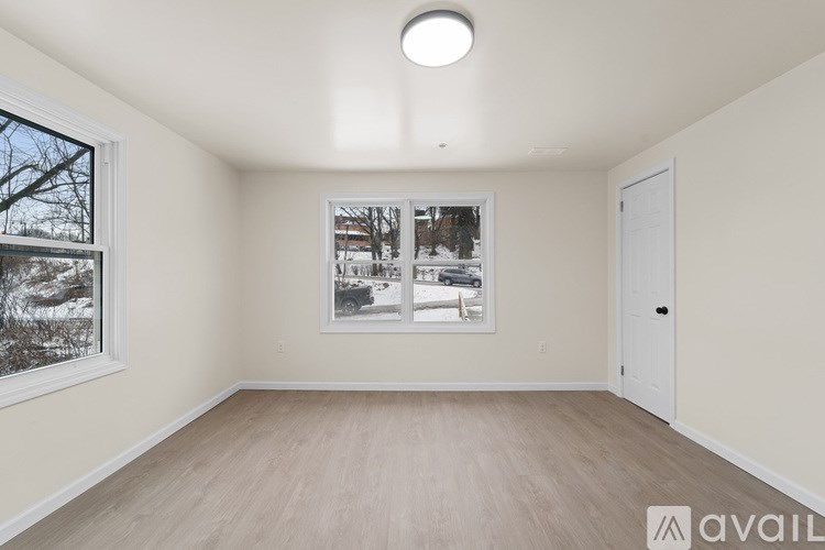 A room with a window showing a snowy scene outside.