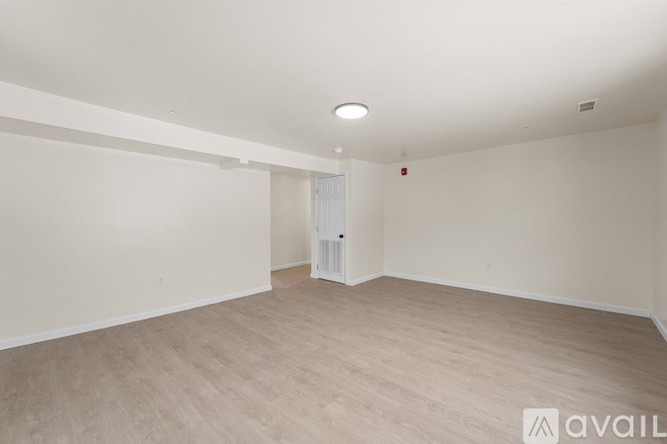 A spacious room with a door and a window.