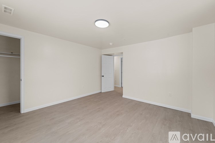 A spacious room with a door and a window.