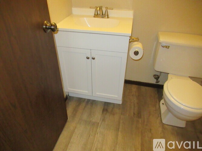 A white sink and toilet in a small bathroom.