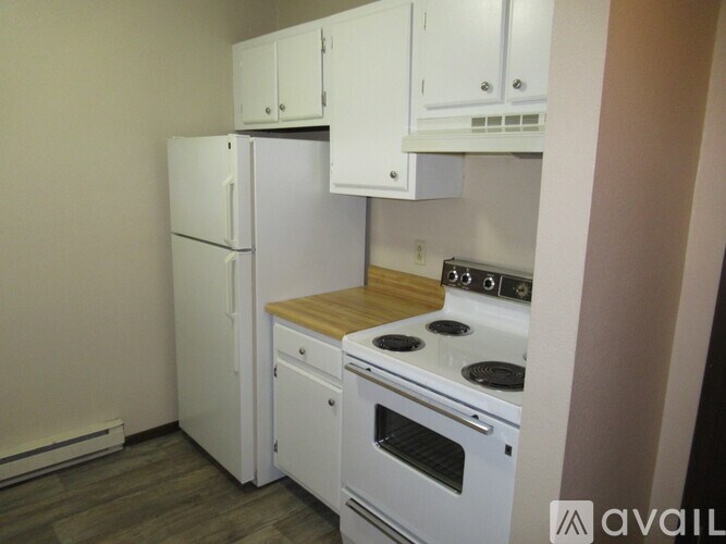 A kitchen with white appliances and cabinets.