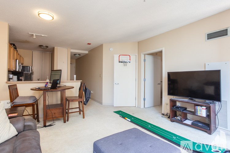 A living room with a basketball hoop on the wall.