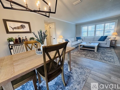 A living room with a wooden table and a sofa.
