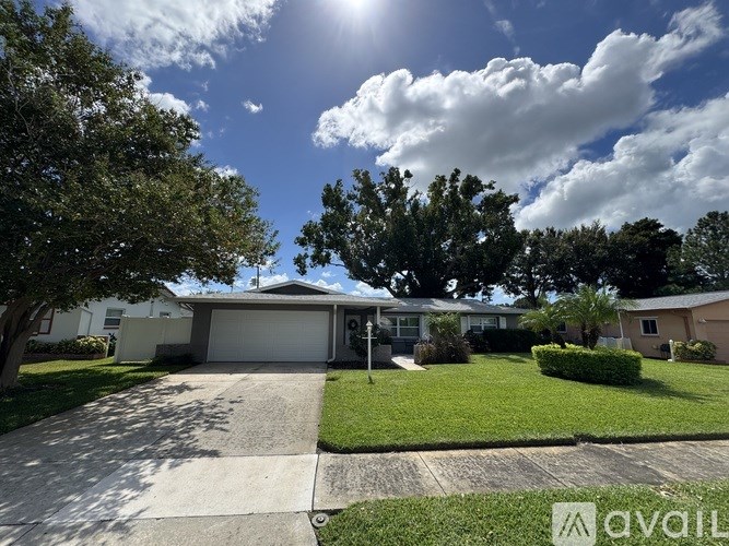 A sunny day in a residential area with houses and greenery.