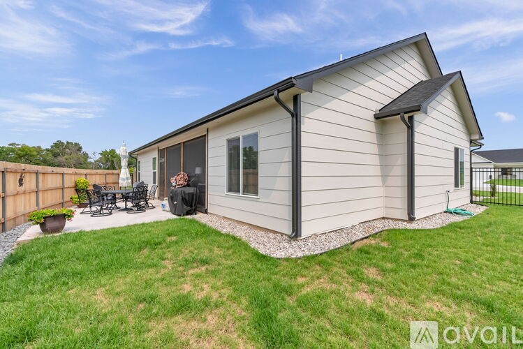 A house with a patio and a black tarp covering it.