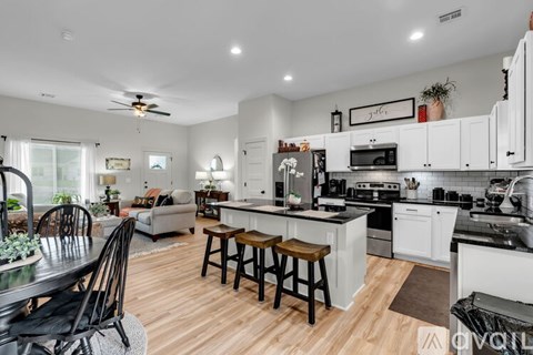 A modern kitchen with white cabinets and a center island.