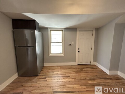 A kitchen with a fridge and a door.