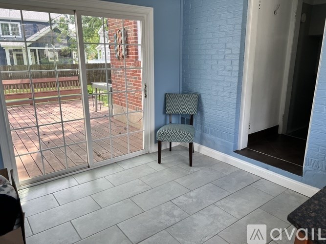 A patio with a chair and a table is shown.