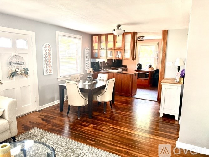 A dining room with a table set for four.