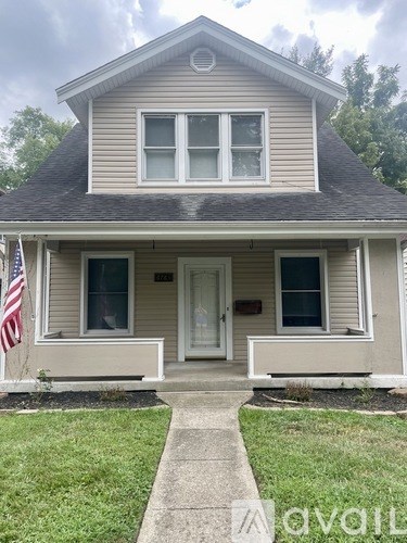 A house with a flag on the front porch.