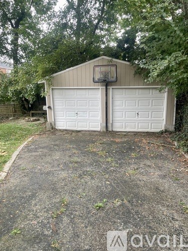 A basketball hoop is attached to a garage door.
