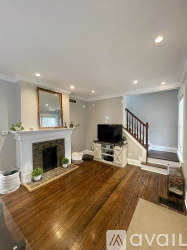 A living room with a fireplace and a television.