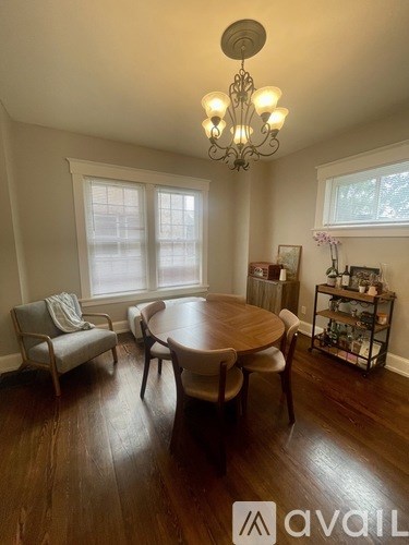 A dining room with a wooden table and chairs.